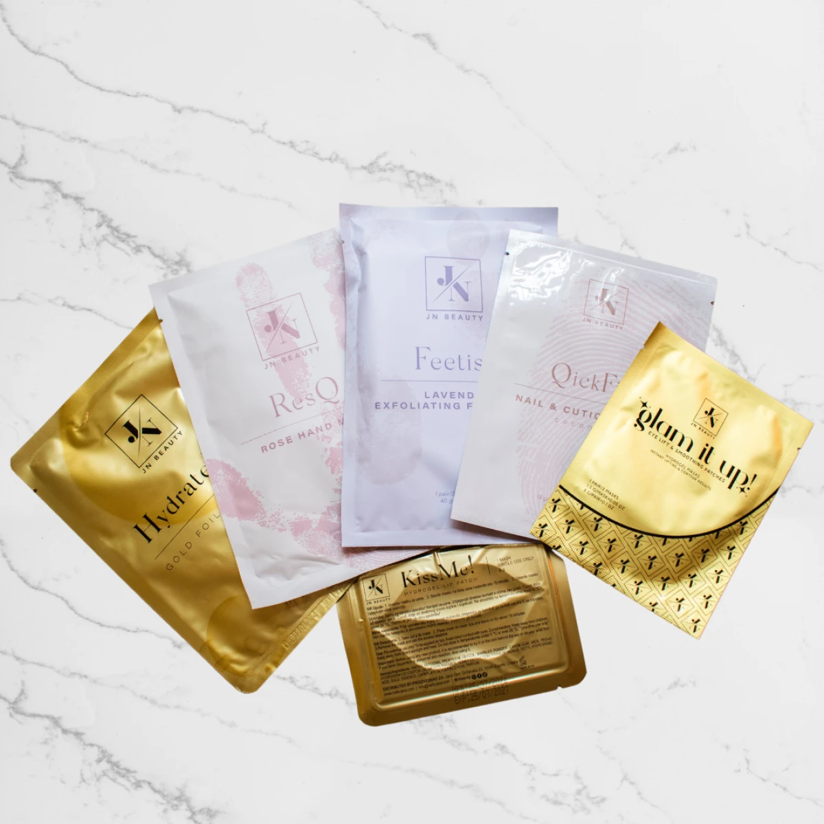 HydrateMe! Gold Foil Face Mask, ResQ Rose Hand Mask, Feetish Lavander Exfoliating Foot Mask, QuickFix Nail & Cuticle Mask Coconut, Glam it Up eye patch, KissMe! hydrogel lip Patch - Gold 